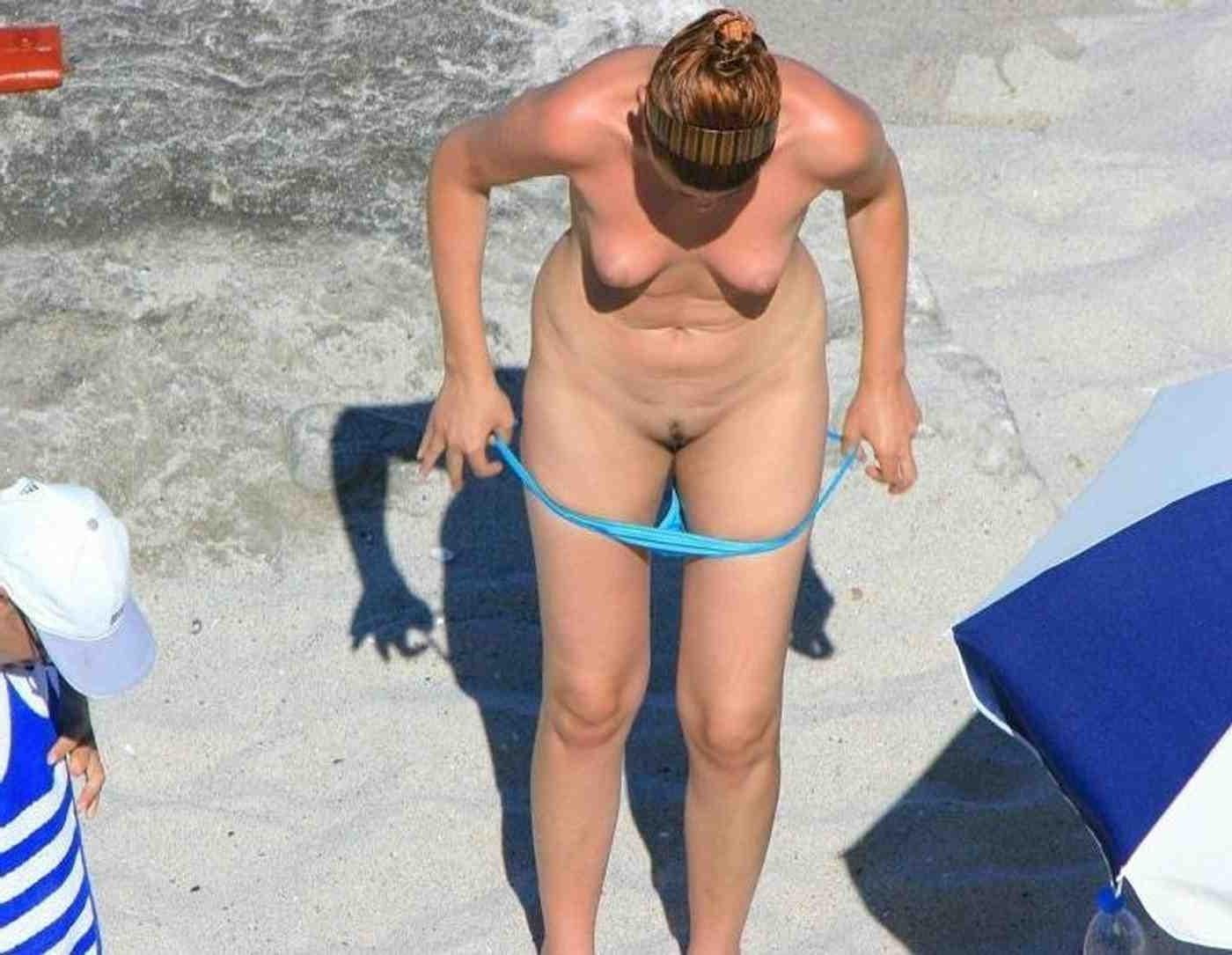 15P Horny hot babe with big tits strips on the beach