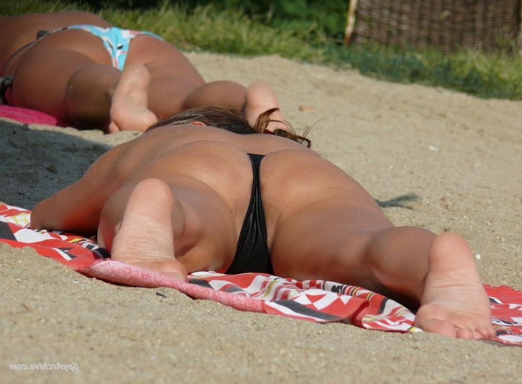 15P Voyeur pictures of a busty brunette on the beach