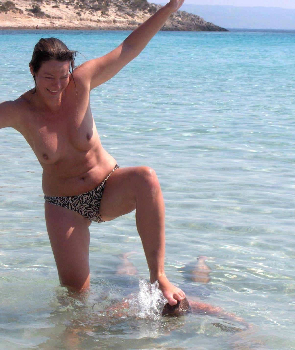 15P Blonde nudist strips down naked at a public beach