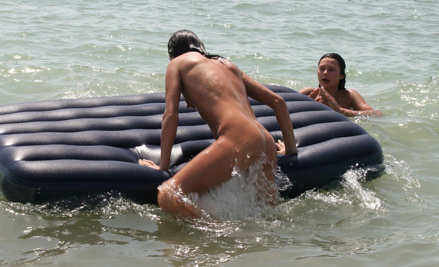15P Nude friends play around at a public beach