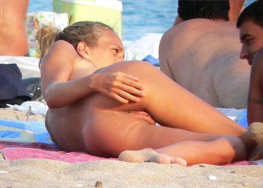 15P Big breasted blonde has some fun being nude on a public beach