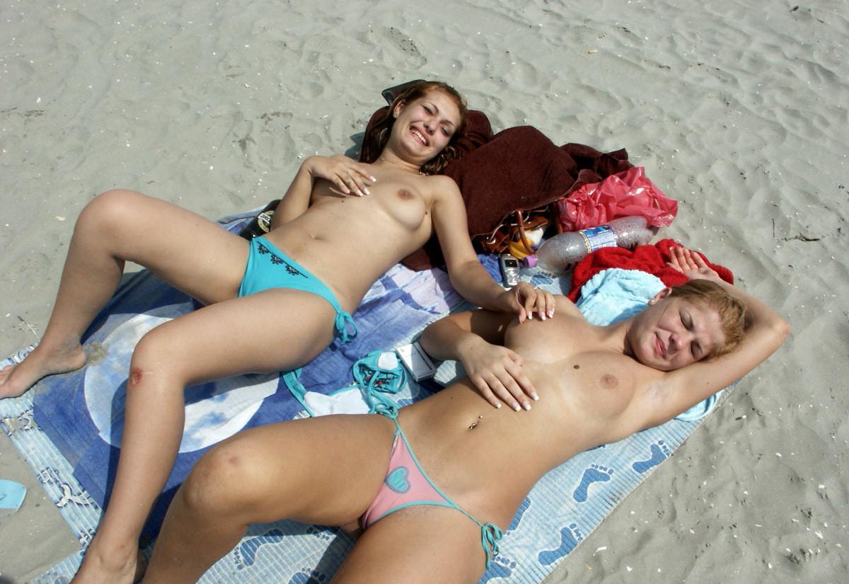 15P Big breasted blonde has some fun being nude on a public beach