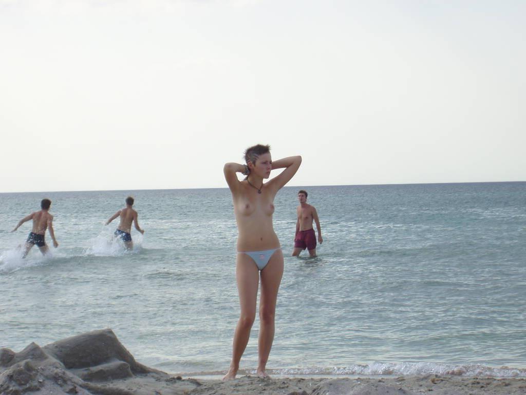 15P Brunette has some fun being nude on a public beach