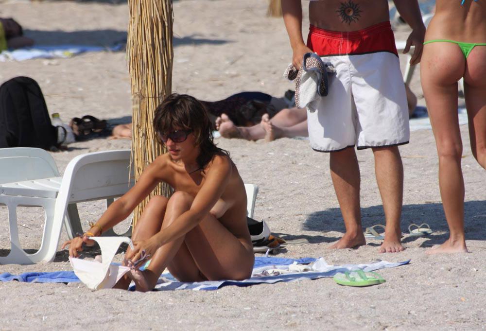 15P Brunette has some fun being nude on a public beach