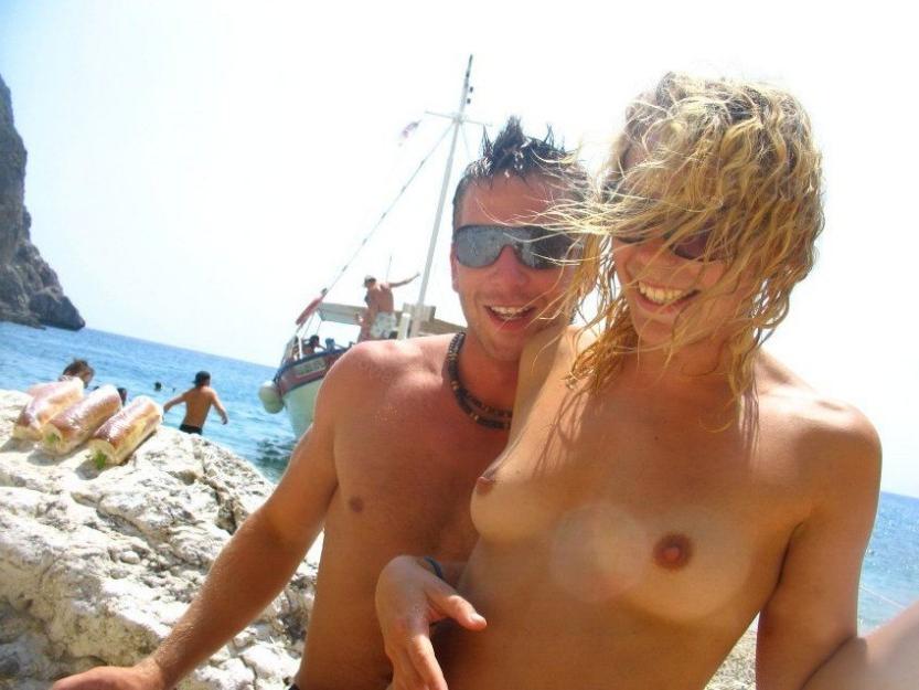15P Nudist chick strips down naked at a public beach