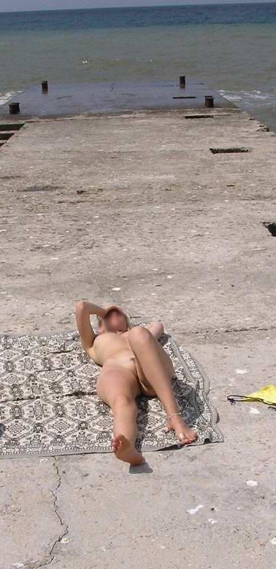 15P Blonde nudist strips down naked at a public beach
