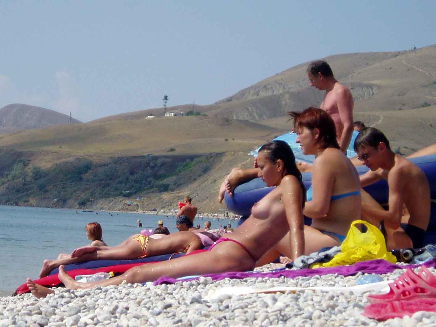 15P Perky breasted beach babe shows off her nude body