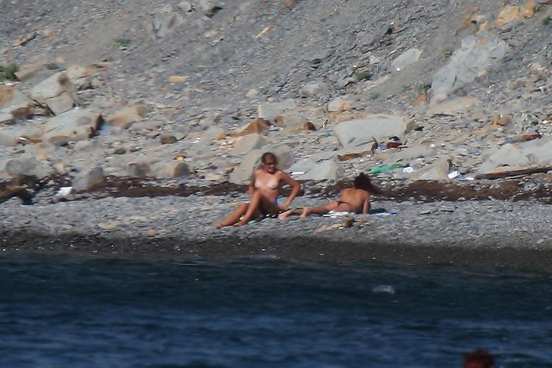 15P Perky breasted beach babe shows off her nude body