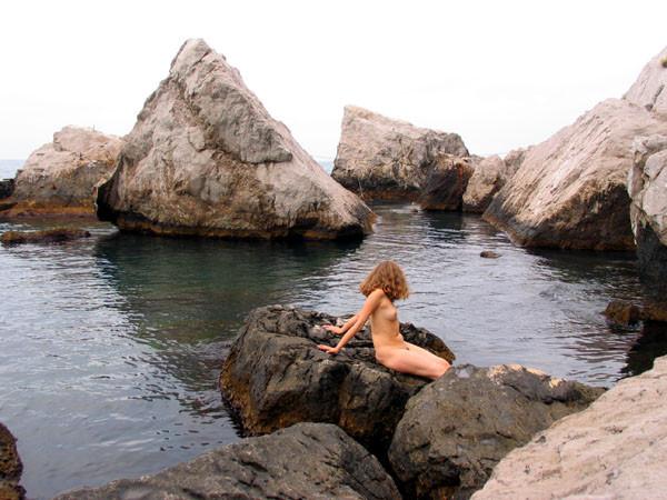 15P Perky breasted beach babe shows off her nude body