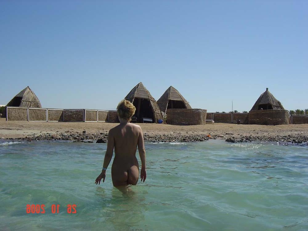 15P Perky breasted beach babe shows off her nude body