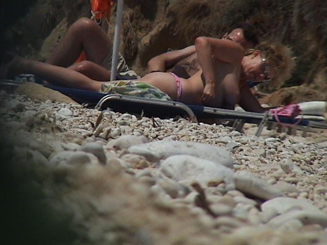 15P Perky breasted beach babe shows off her nude body