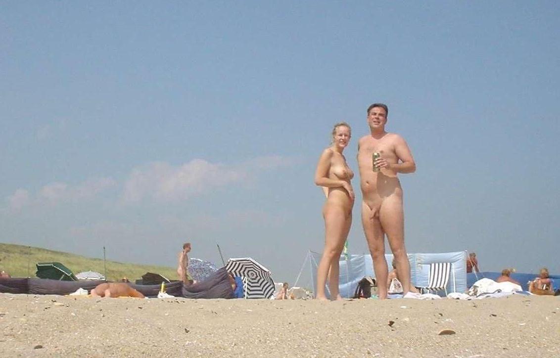 15P Perky breasted beach babe shows off her nude body