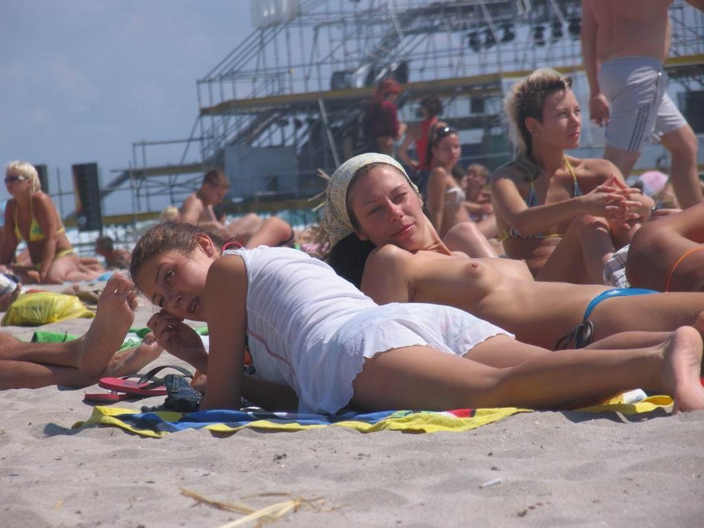 15P Perky breasted beach babe shows off her nude body