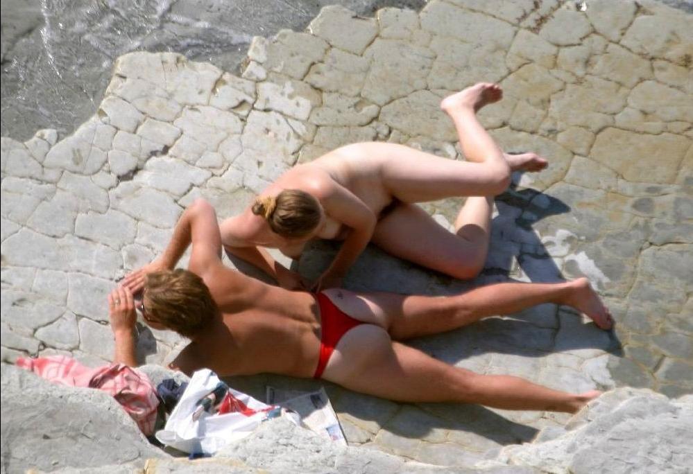 15P Busty milf not shy about posing nude at the beach