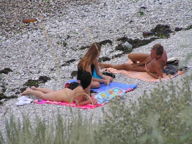 15P Friendly young Russian nudists lay on the beach