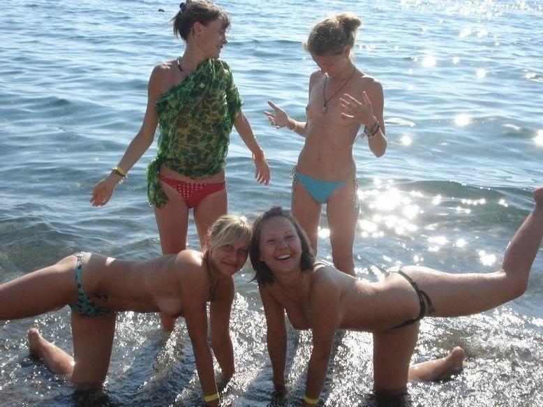 15P Busty chick shows her naked body at the nude beach