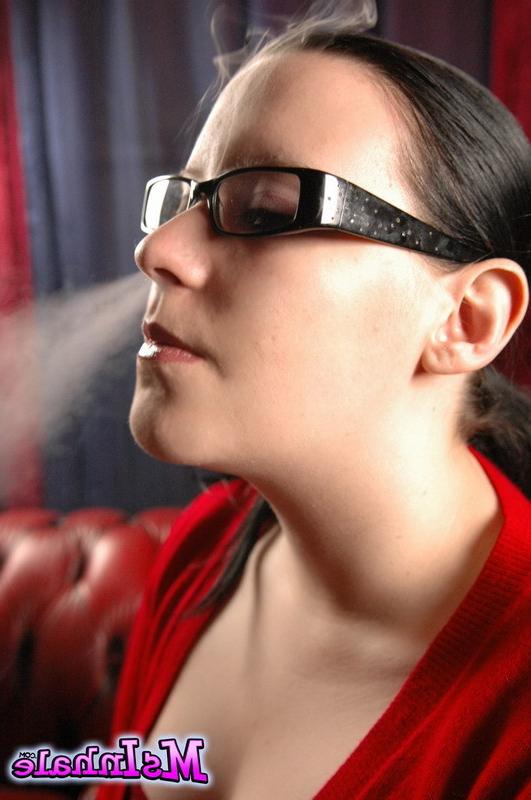 16P Cute teen in glasses smokes a menthol cigarette