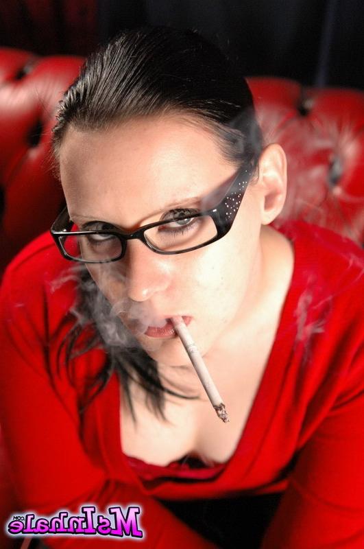 16P Cute teen in glasses smokes a menthol cigarette