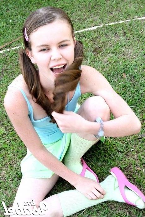 16P Small teen girl in short skirt and pigtails