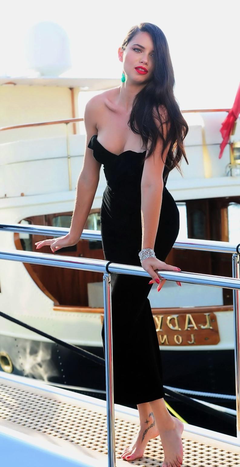 16P Adriana Lima busty in black strapless dress boarding on a yacht in Cannes