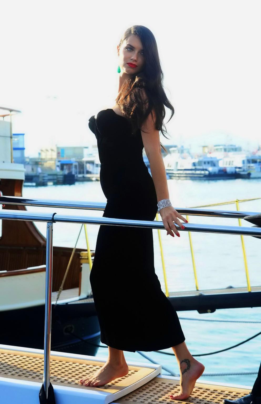 16P Adriana Lima busty in black strapless dress boarding on a yacht in Cannes