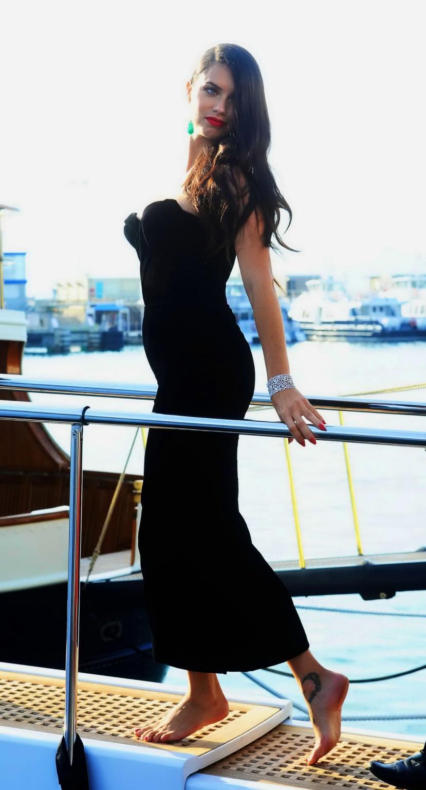 16P Adriana Lima busty in black strapless dress boarding on a yacht in Cannes