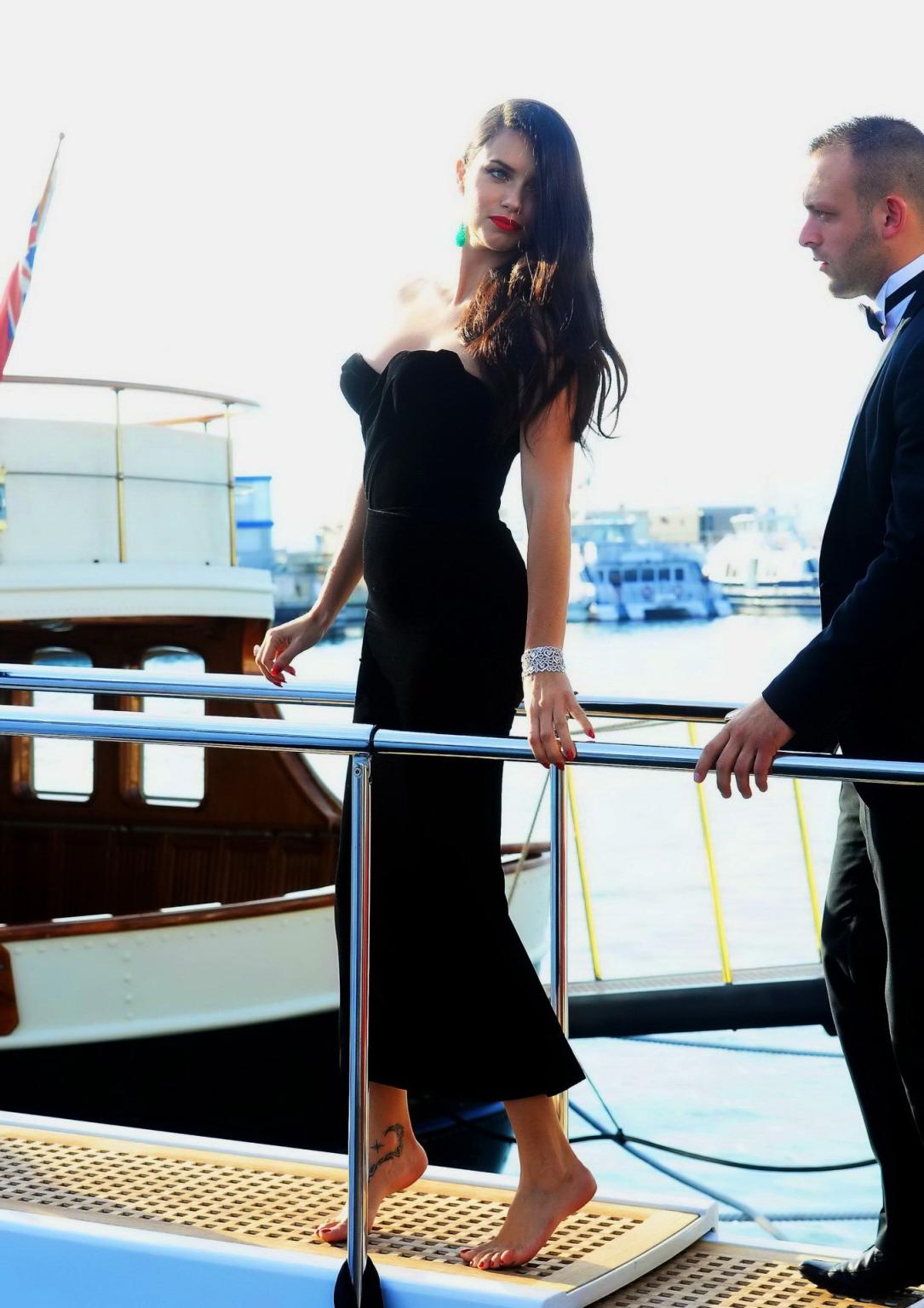 16P Adriana Lima busty in black strapless dress boarding on a yacht in Cannes