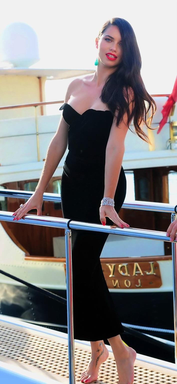 16P Adriana Lima busty in black strapless dress boarding on a yacht in Cannes