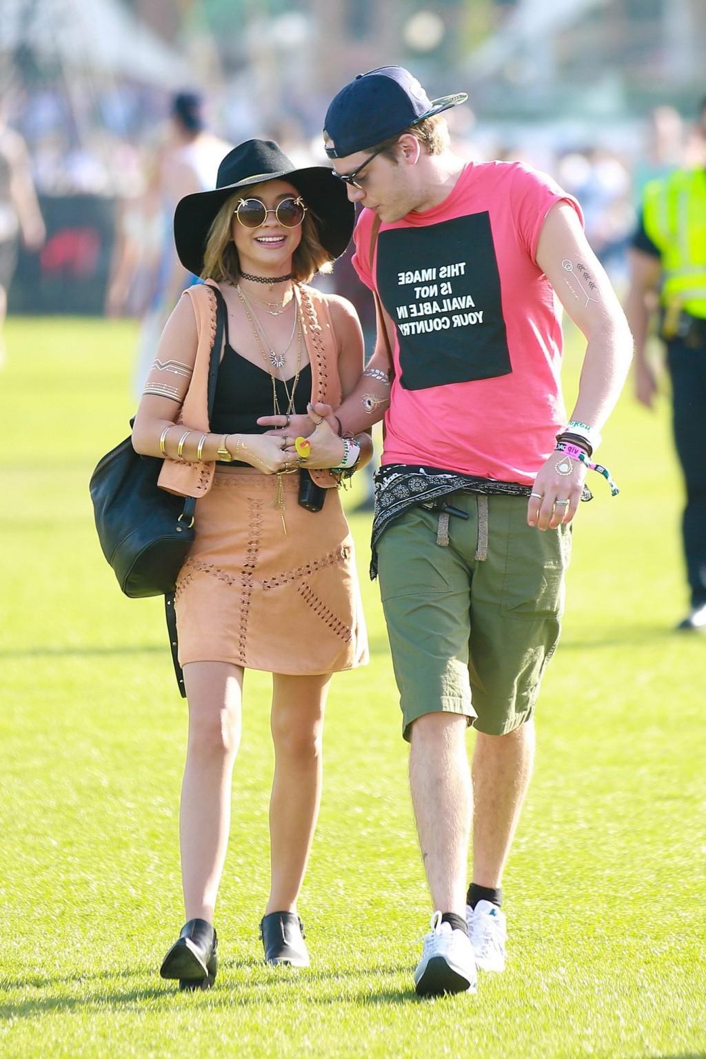 16P Sarah Hyland cleavy and leggy in black top and leather mini skirt at Coachella V