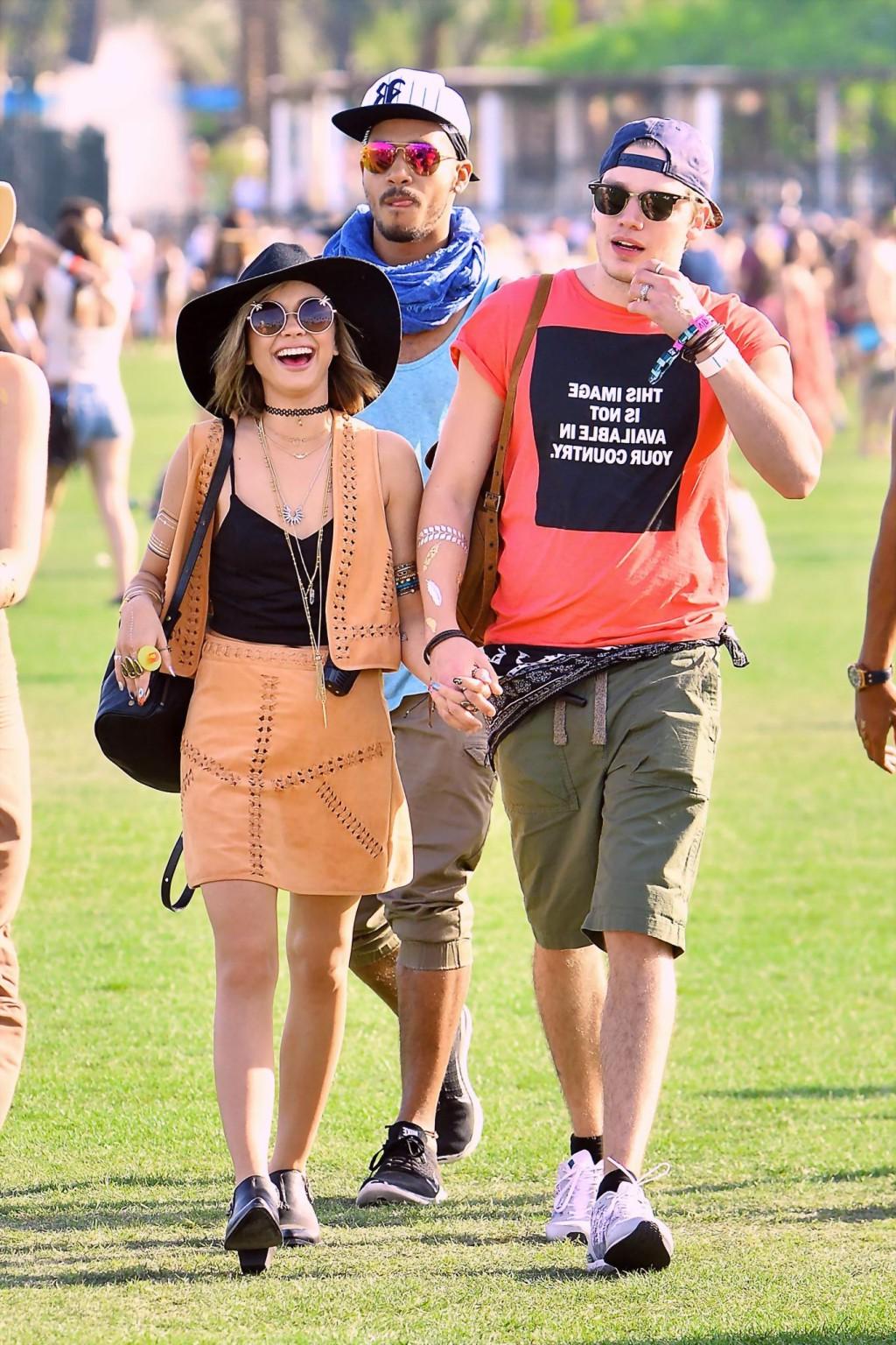 16P Sarah Hyland cleavy and leggy in black top and leather mini skirt at Coachella V