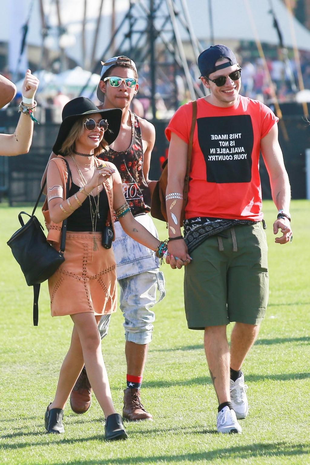 16P Sarah Hyland cleavy and leggy in black top and leather mini skirt at Coachella V