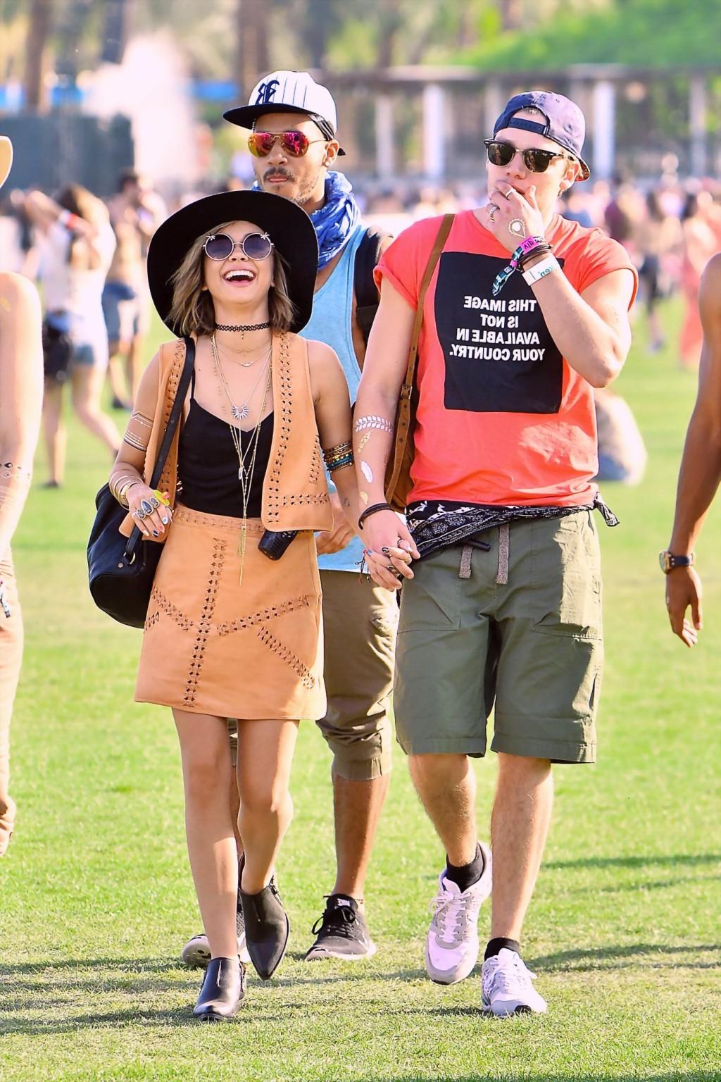 16P Sarah Hyland cleavy and leggy in black top and leather mini skirt at Coachella V