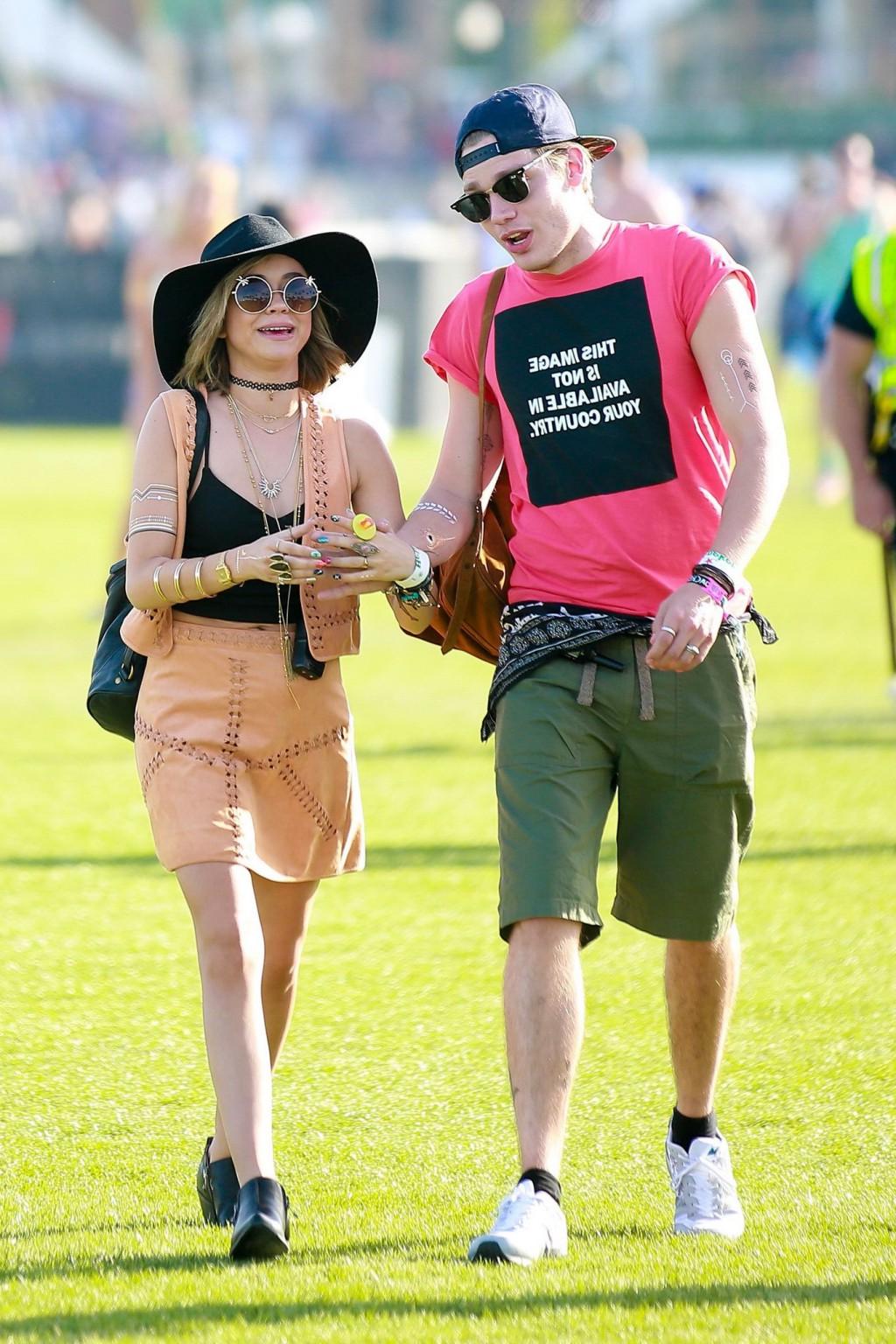 16P Sarah Hyland cleavy and leggy in black top and leather mini skirt at Coachella V