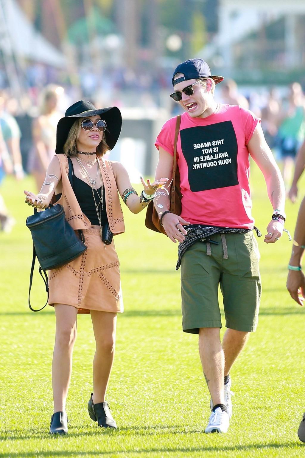 16P Sarah Hyland cleavy and leggy in black top and leather mini skirt at Coachella V
