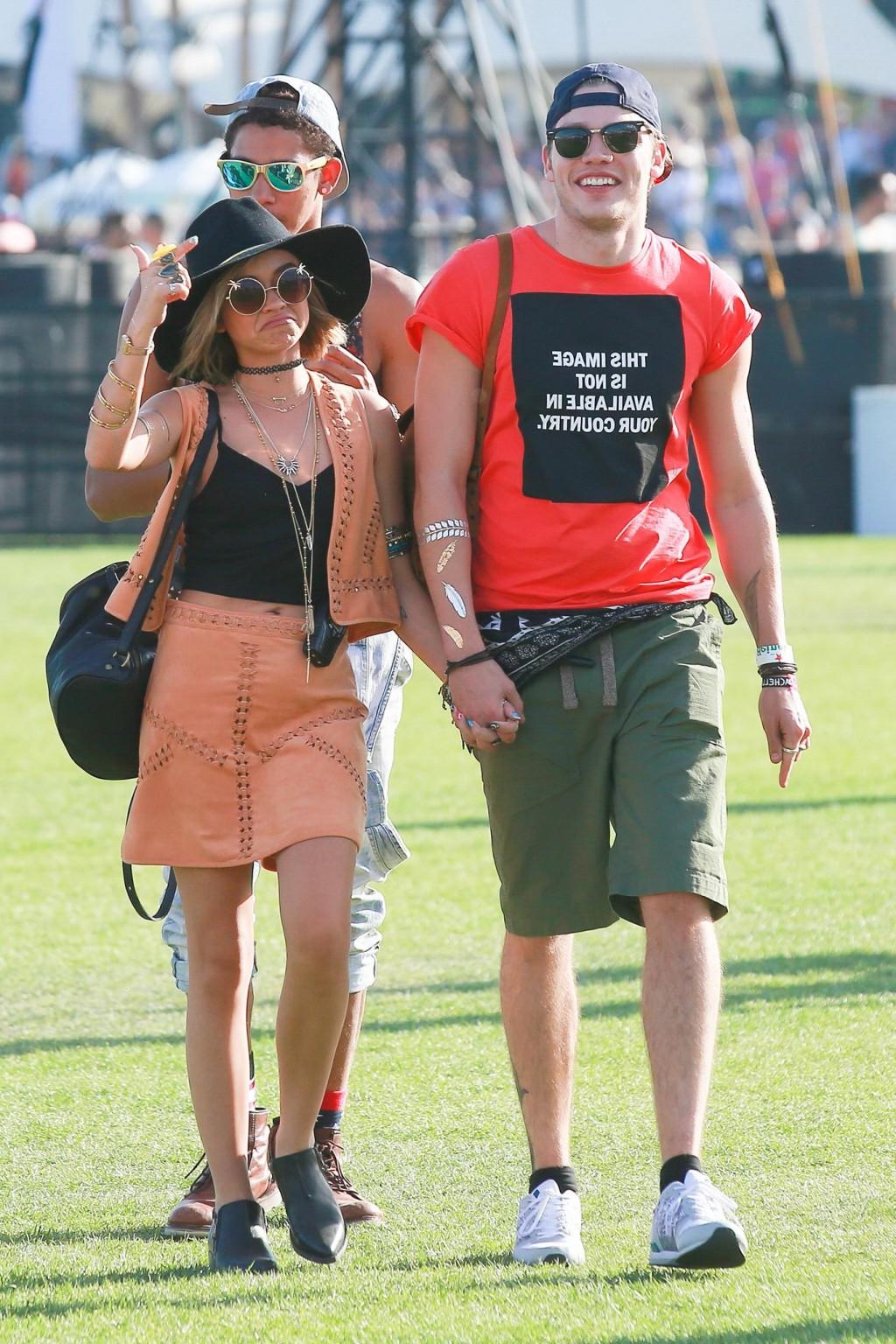 16P Sarah Hyland cleavy and leggy in black top and leather mini skirt at Coachella V