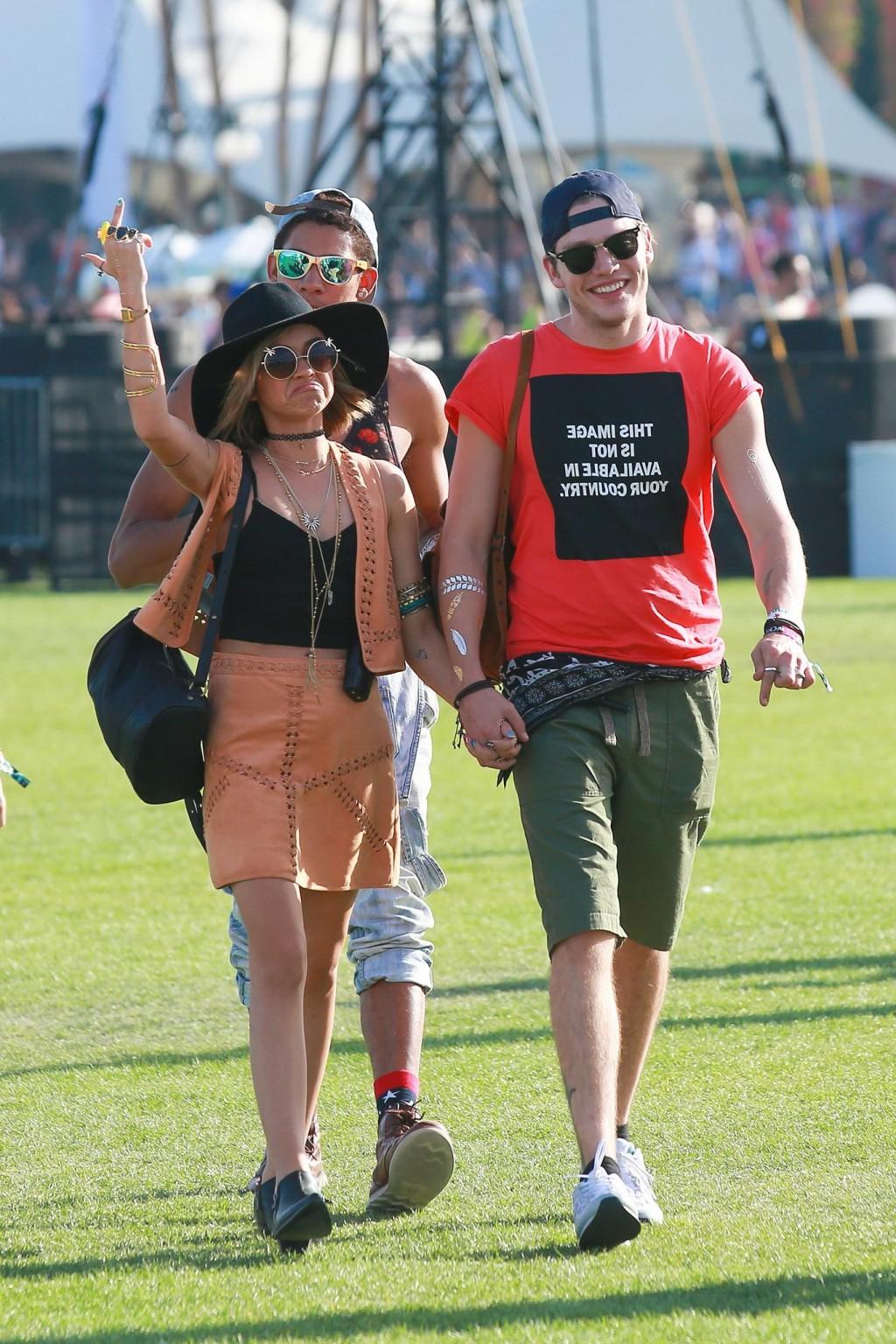 16P Sarah Hyland cleavy and leggy in black top and leather mini skirt at Coachella V
