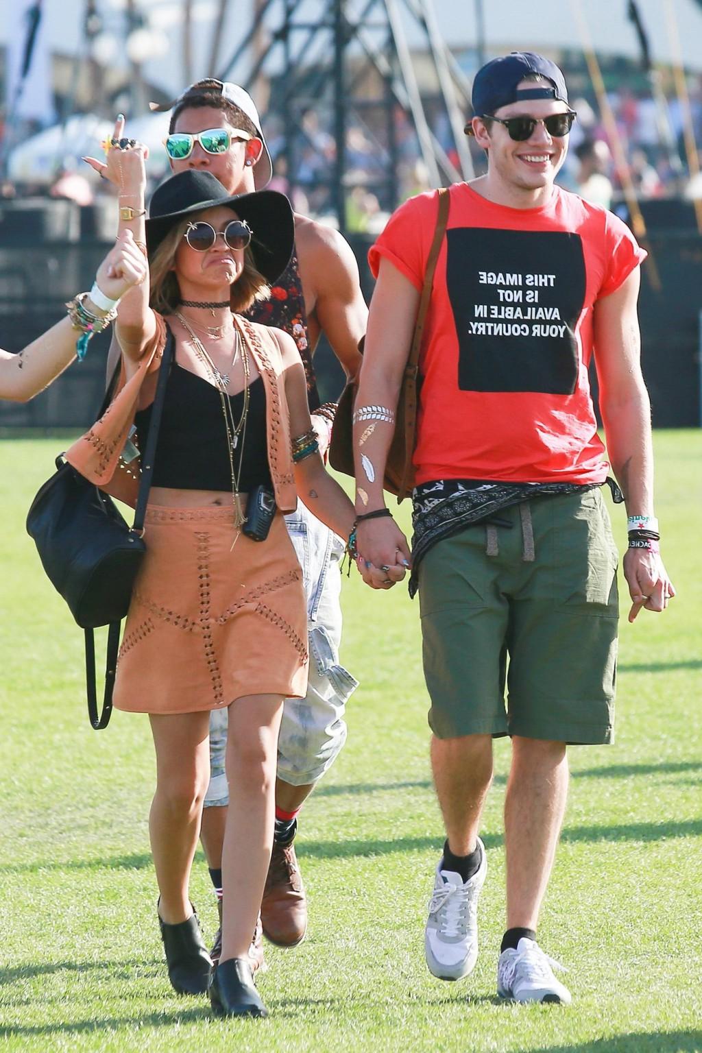 16P Sarah Hyland cleavy and leggy in black top and leather mini skirt at Coachella V