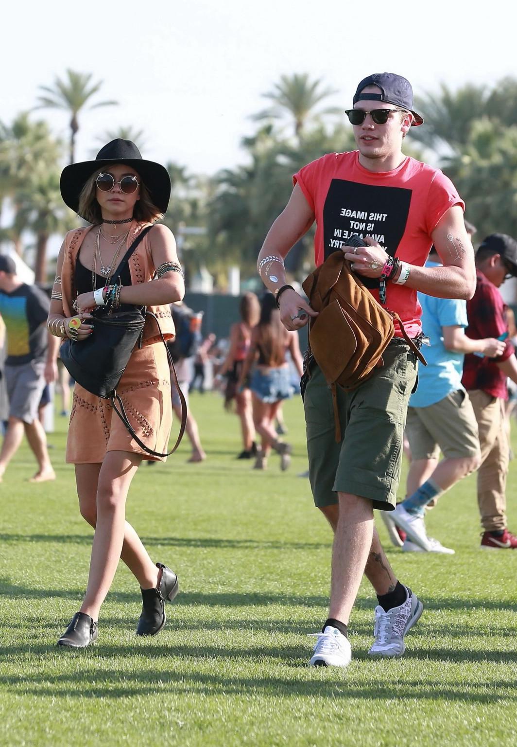 16P Sarah Hyland cleavy and leggy in black top and leather mini skirt at Coachella V