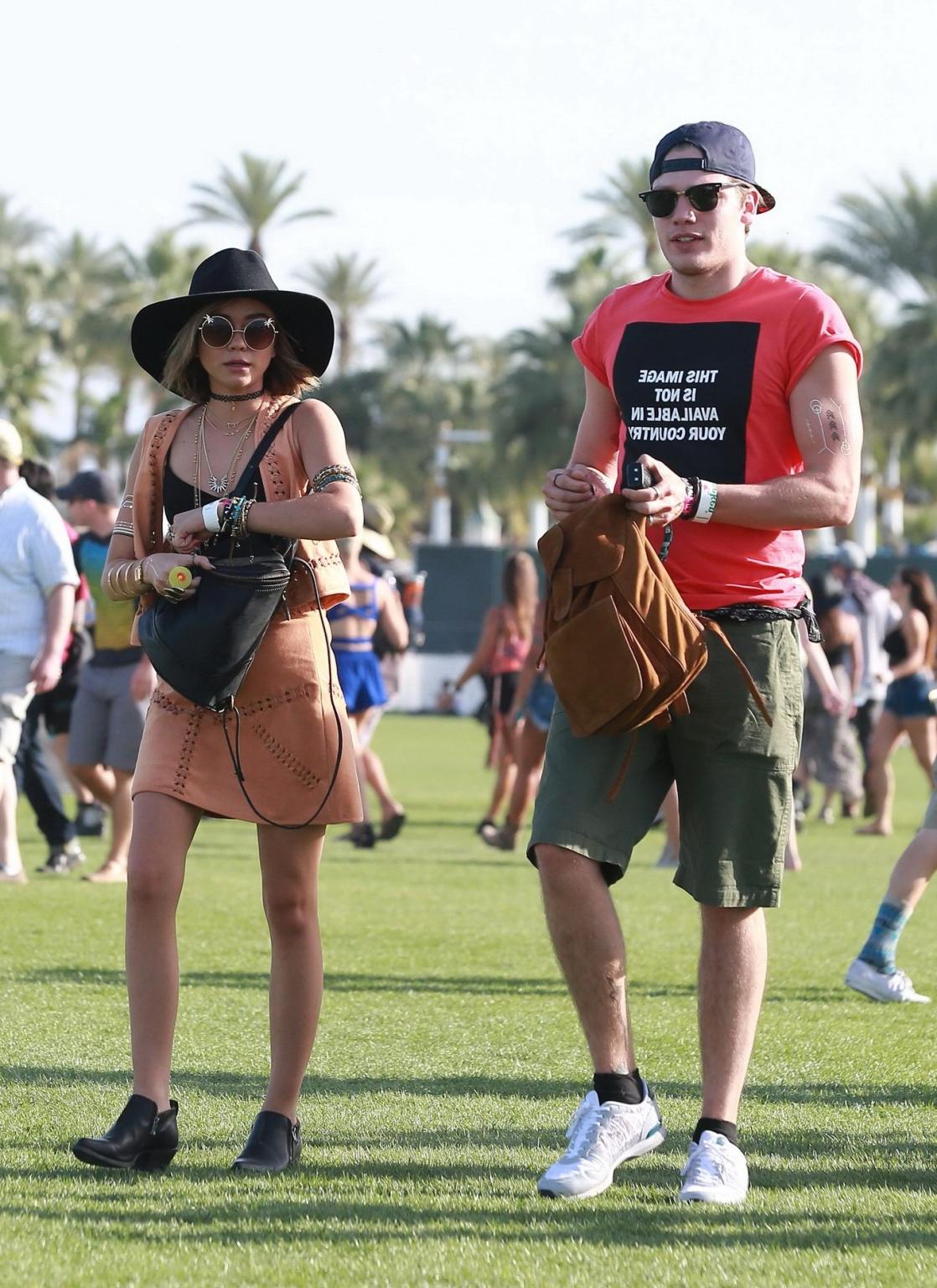 16P Sarah Hyland cleavy and leggy in black top and leather mini skirt at Coachella V