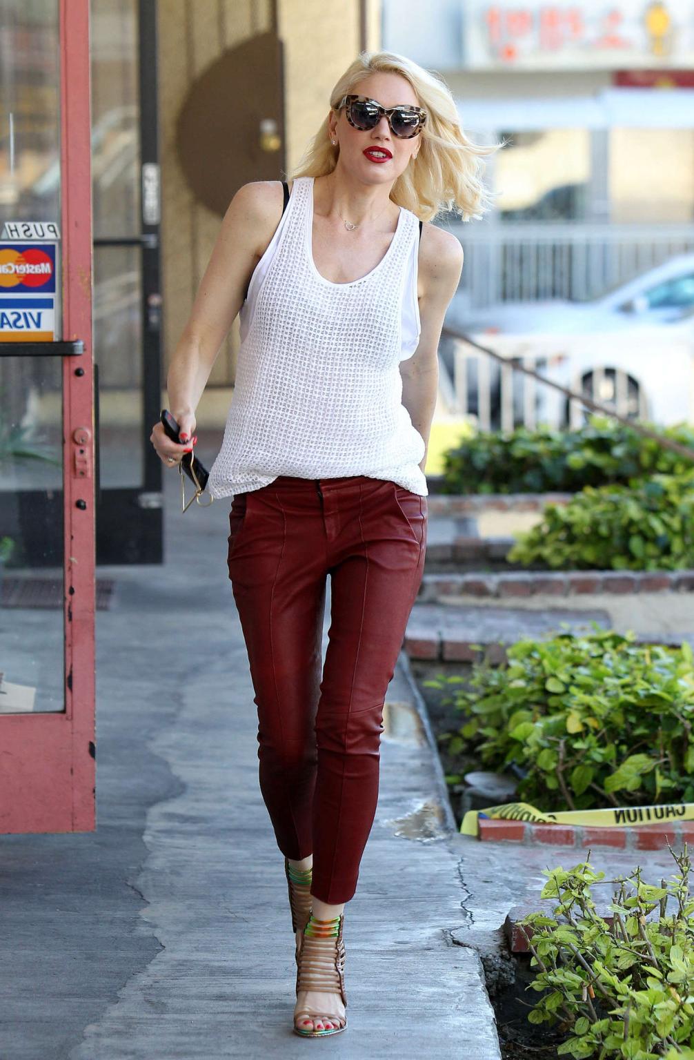 16P Gwen Stefani busty in white see through top and red leather pants arriving to he