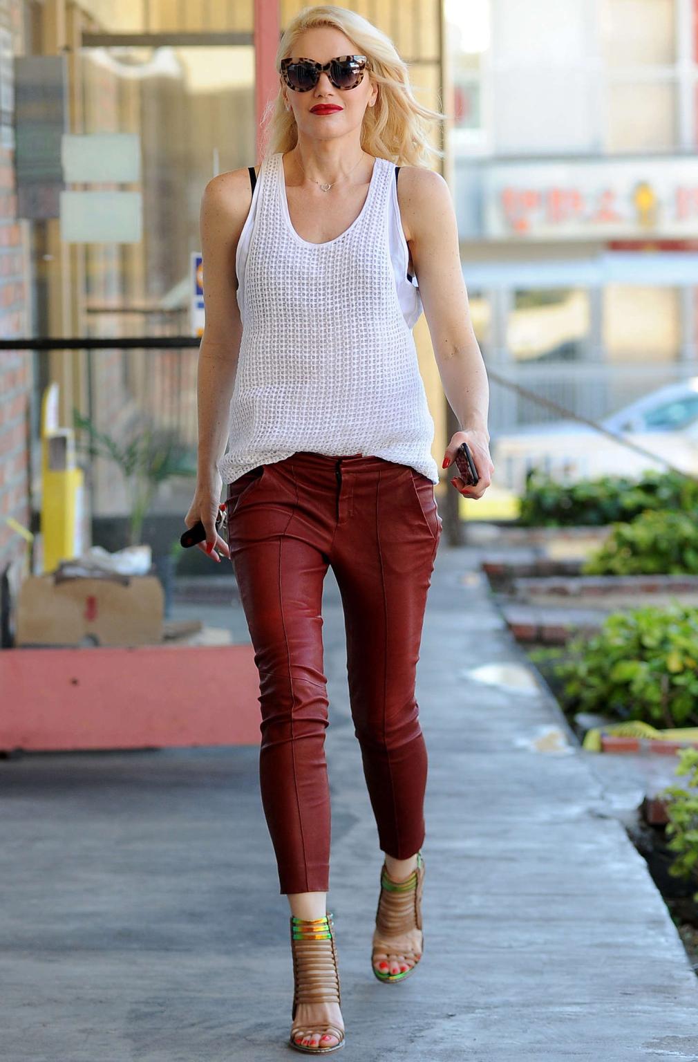 16P Gwen Stefani busty in white see through top and red leather pants arriving to he
