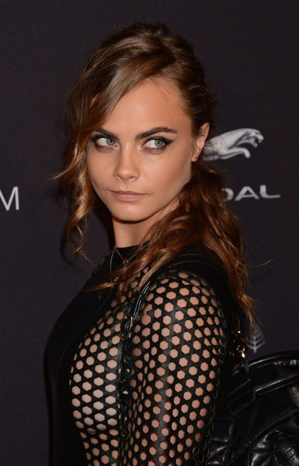 16P Cara Delevingne shows sideboobs wearing a partially see through leather dress at