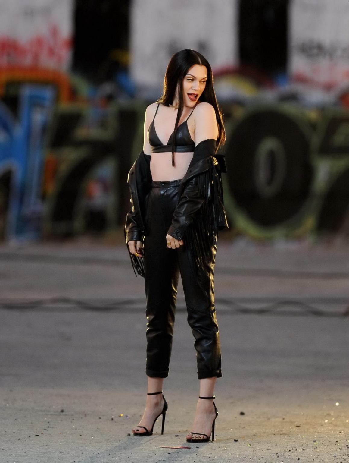 16P Jessie J showing boobs in tiny black leather bra on the set of her new music vid