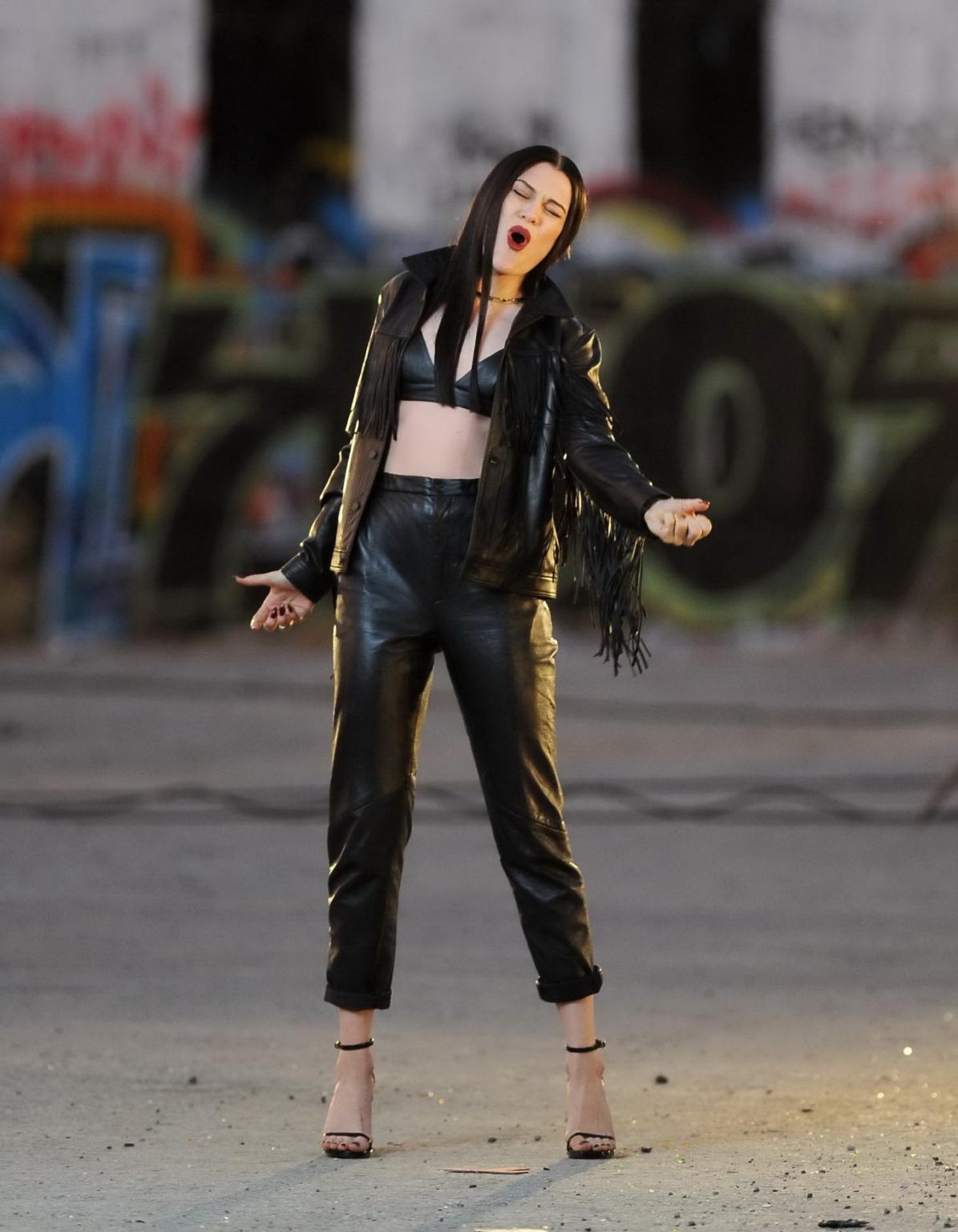16P Jessie J showing boobs in tiny black leather bra on the set of her new music vid