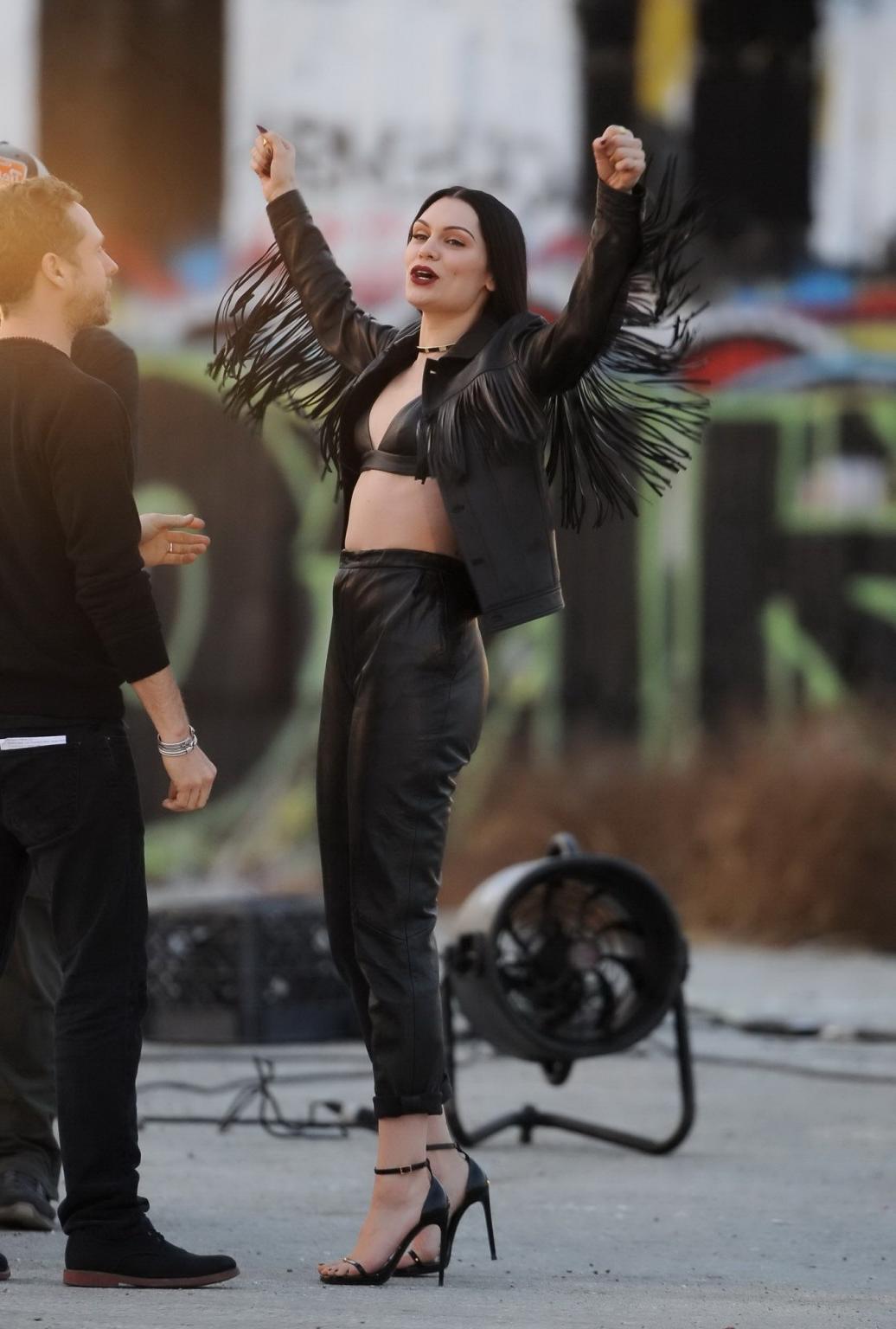 16P Jessie J showing boobs in tiny black leather bra on the set of her new music vid