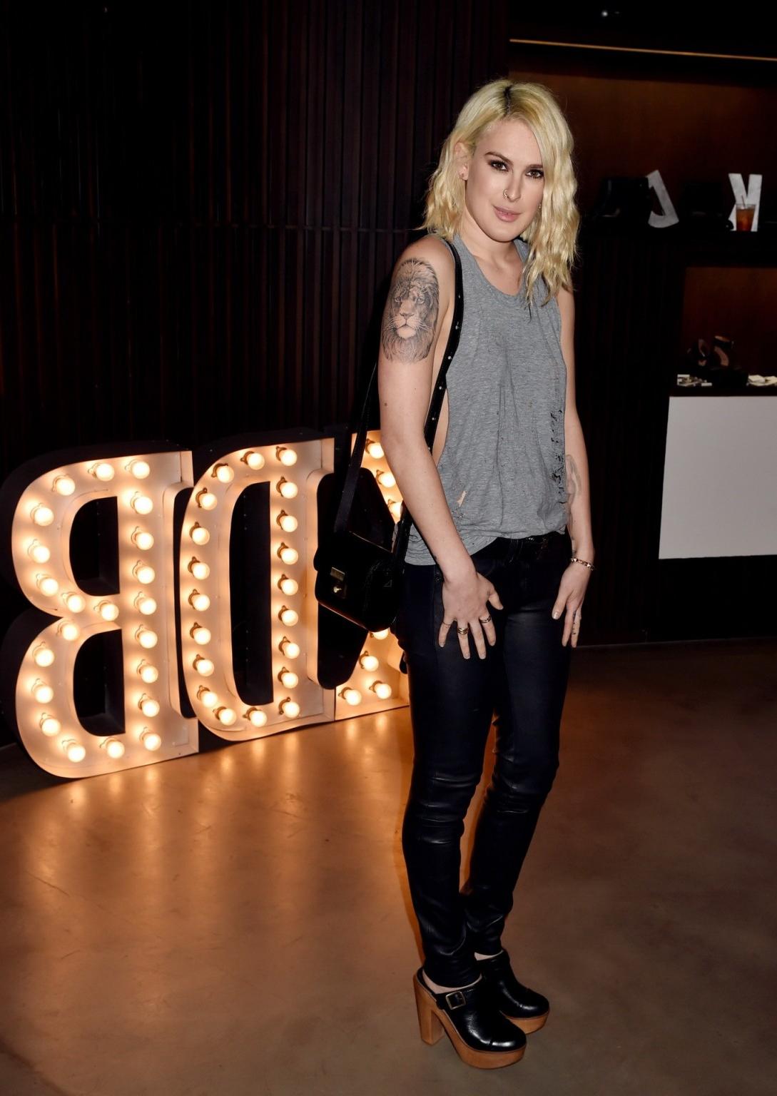 16P Rumer Willis shows sideboob braless in a ripped top and leather pants at the eve