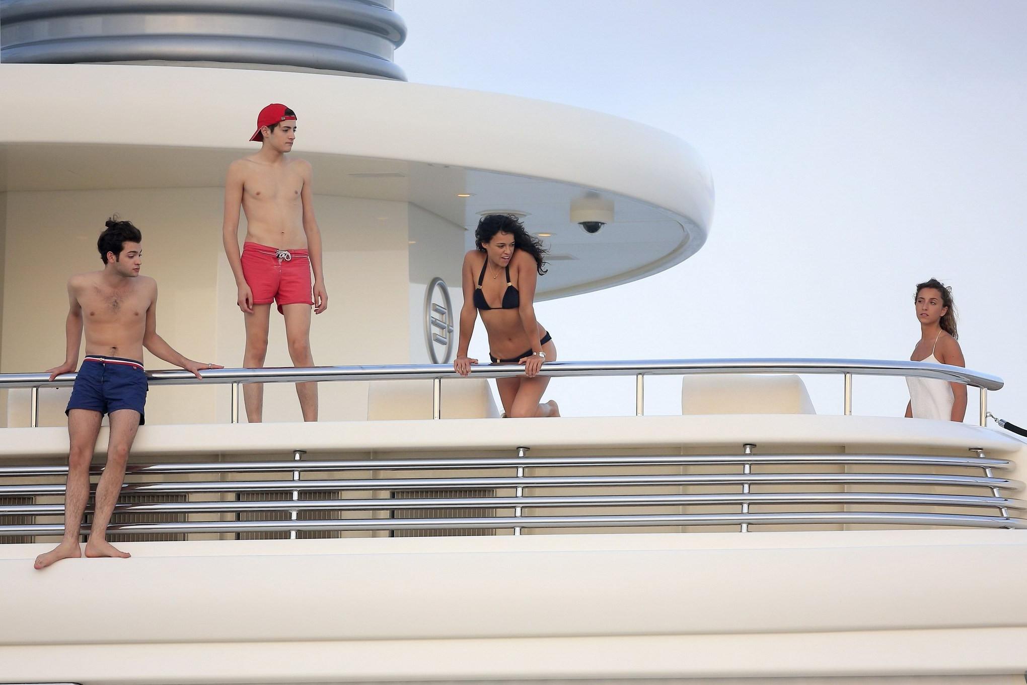 16P Michelle Rodriguez wearing a sexy black bikini on a yacht in Formentera