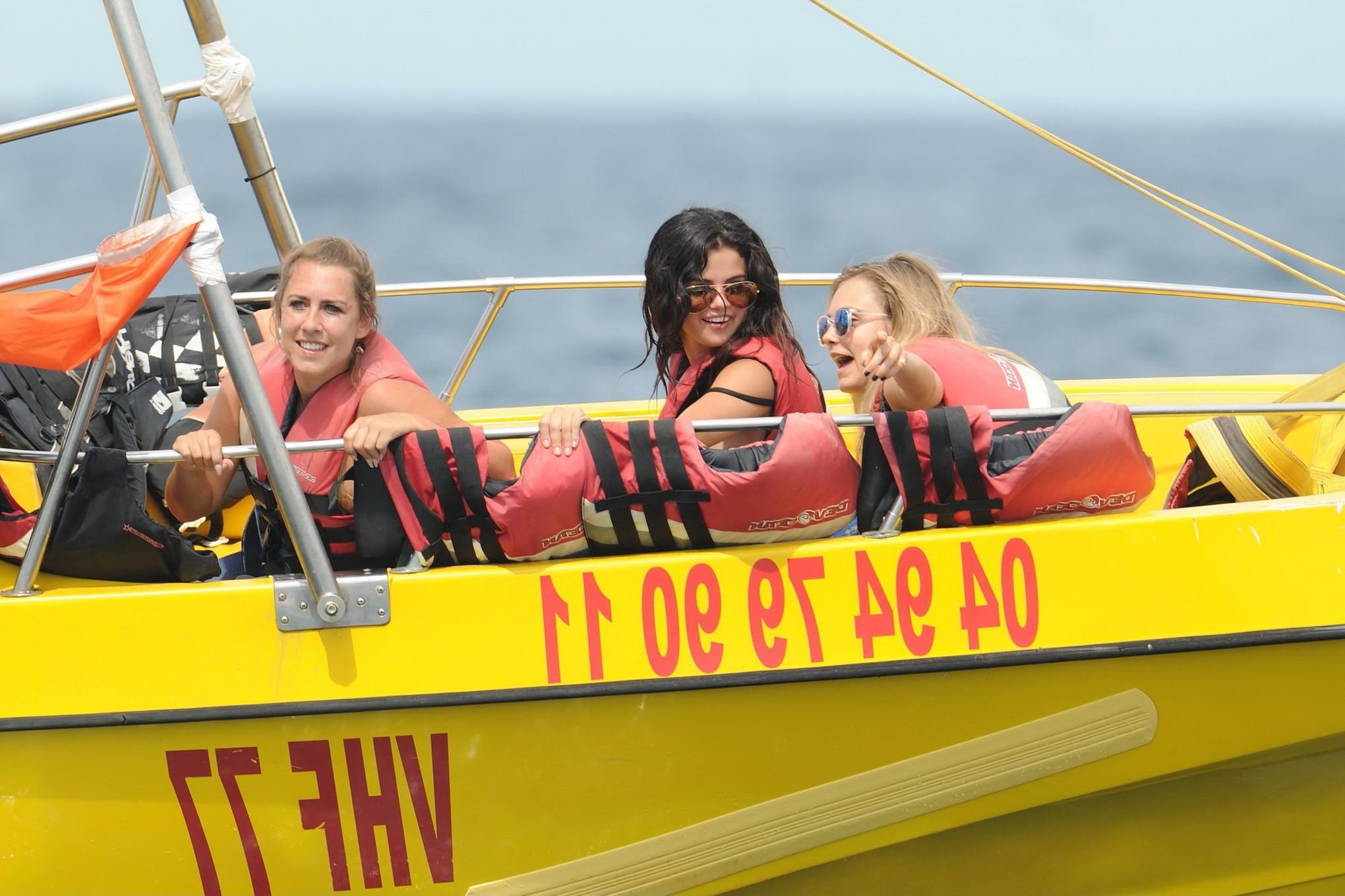 16P Selena Gomez and Cara Delevingne wearing skimpy black bikinis at a yacht in Sain