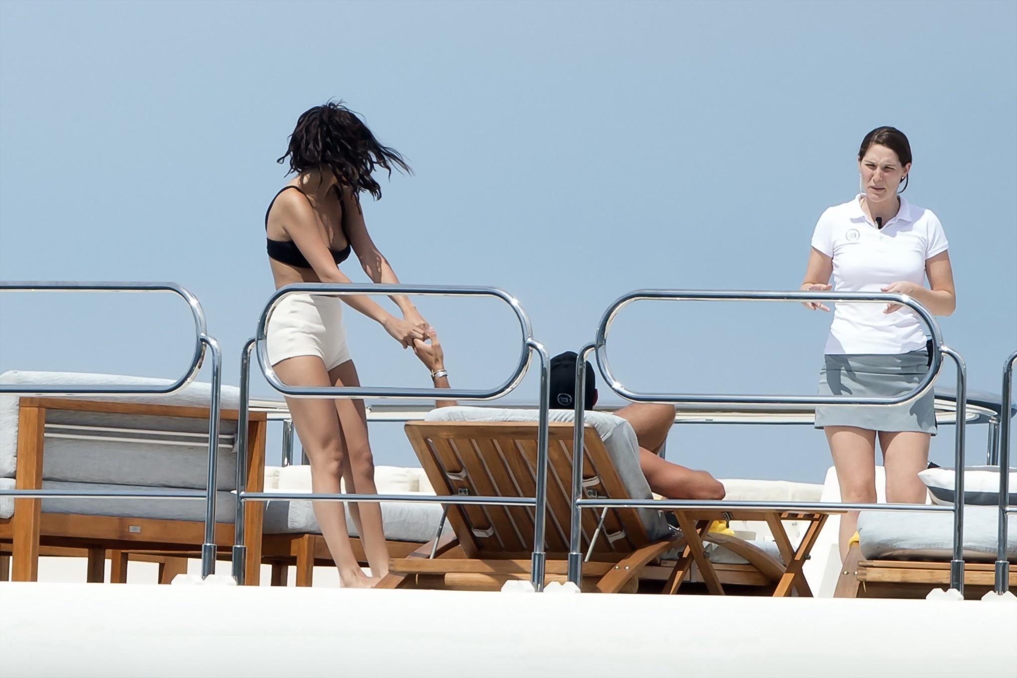 16P Selena Gomez and Cara Delevingne wearing skimpy black bikinis at a yacht in Sain