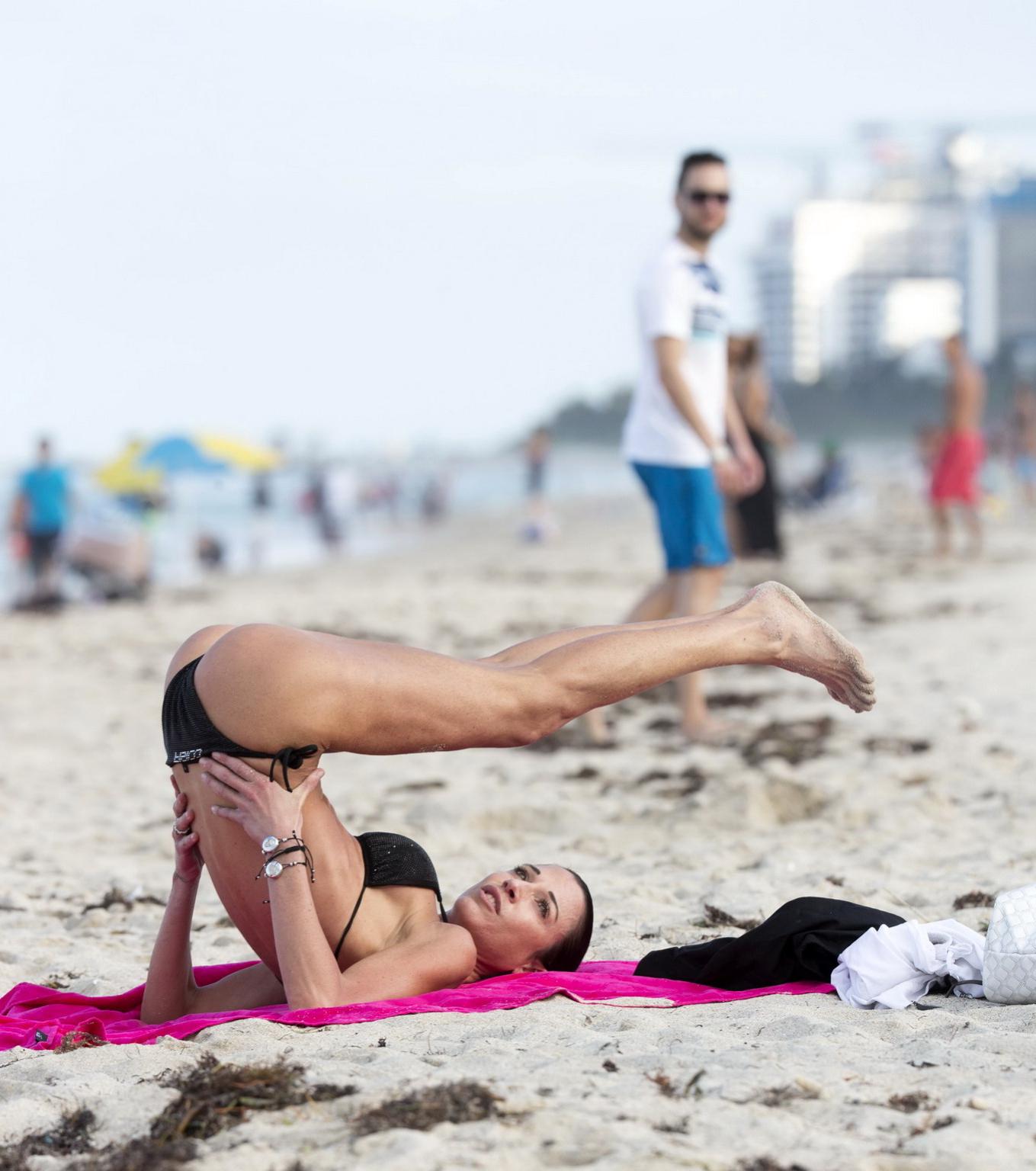 16P Federica Torti in black bikini doing yoga on a beach in Miami